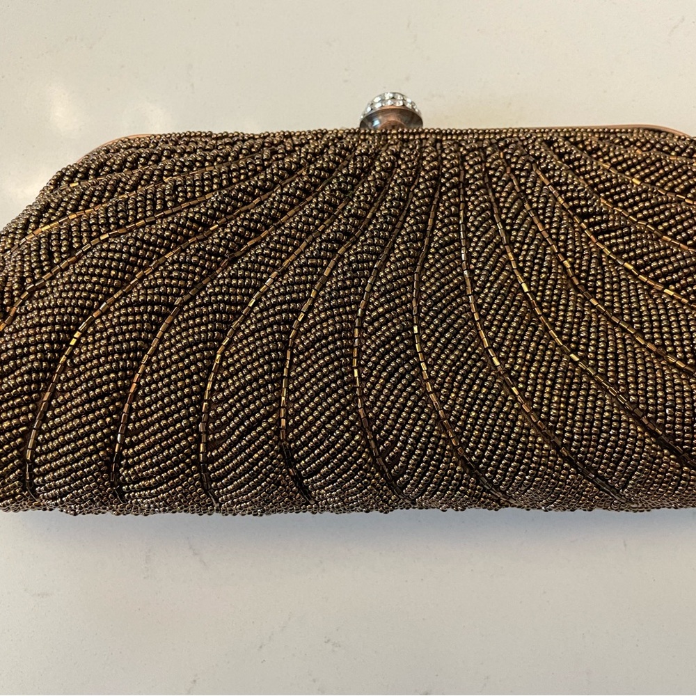 Vintage bronze beaded clutch. Accented with “diamond” clasp.